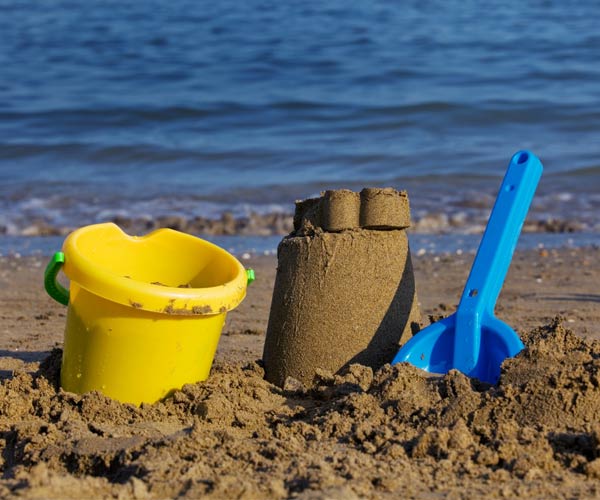 Beach pail, shovel and sand castle