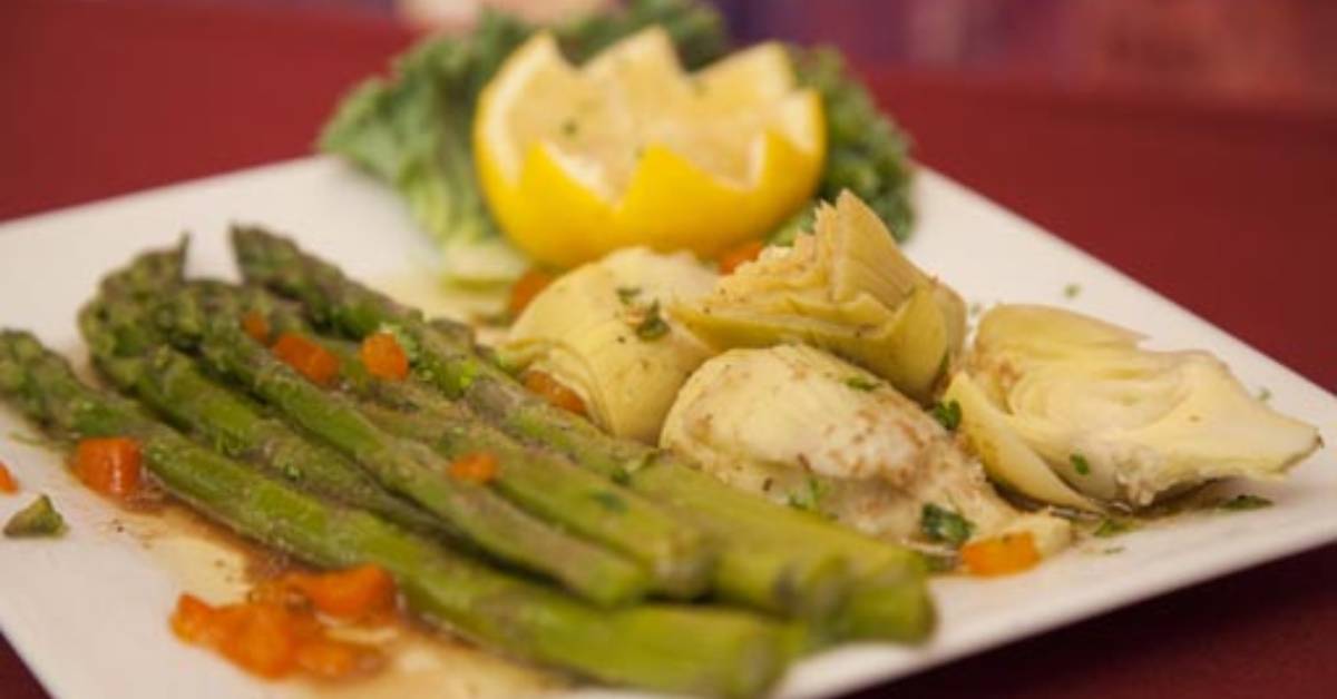 a plate of food with asparagus and other items