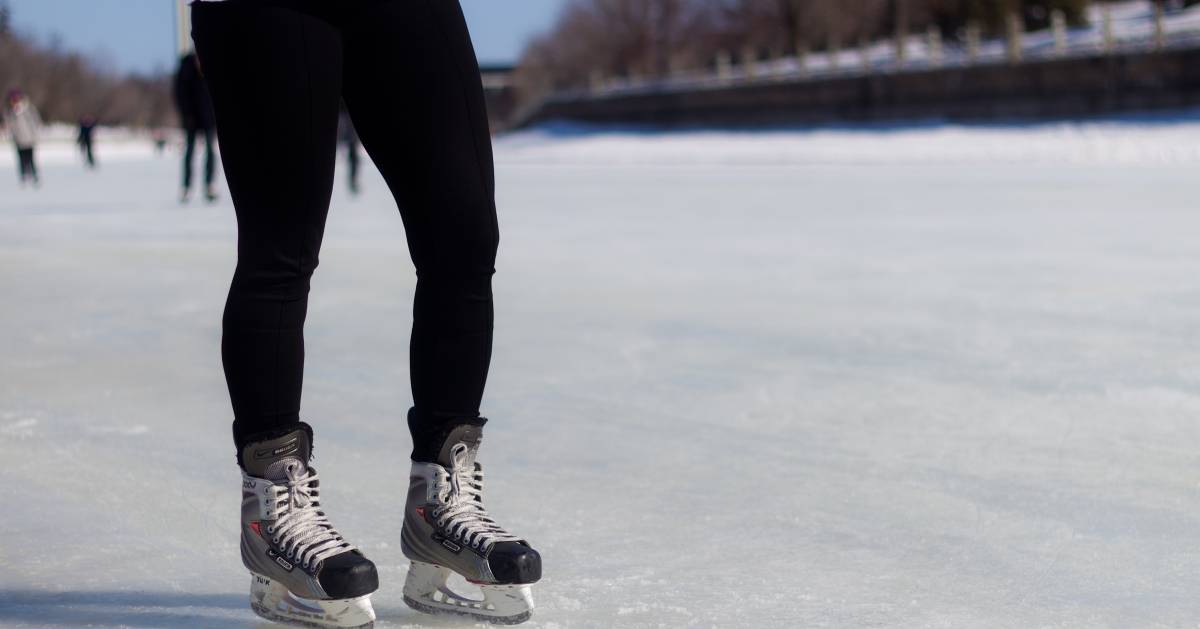 person wearing black pants and ice skates