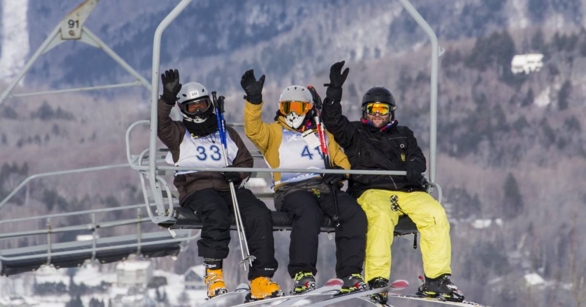 skiers on a ski lift