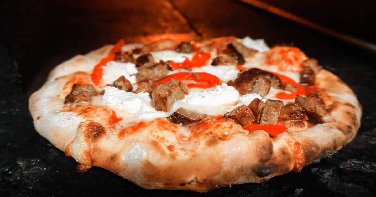 wood fired pizza with sausage, ricotta, and red peppers