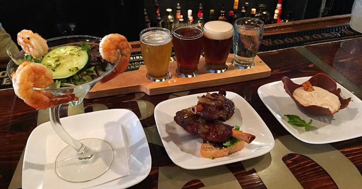 beer glasses and plates of food