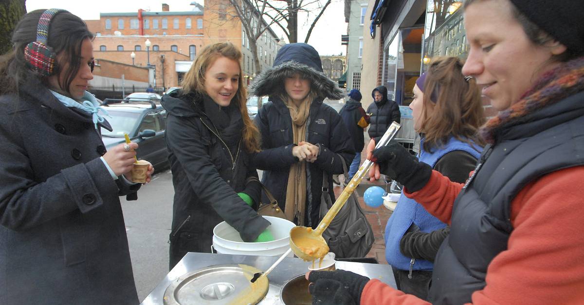 people sampling chowder outdoors