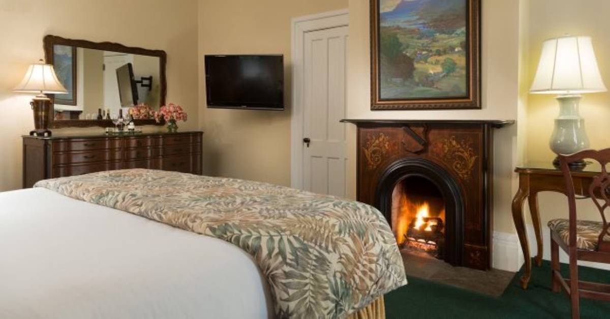 hotel with a bed and a fireplace
