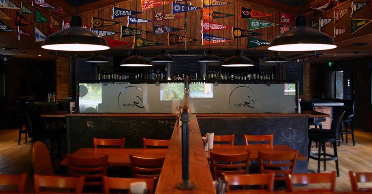 restaurant dining room with tables and flags on the wall
