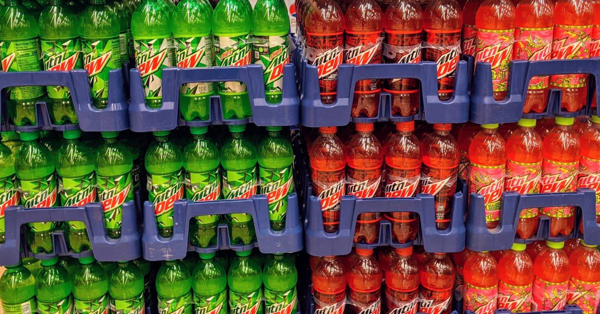 stacks of bottled Mountain Dew in three different flavors