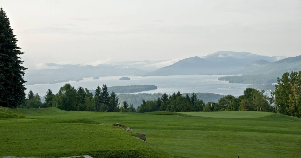 golf course and views of a lake and mountains