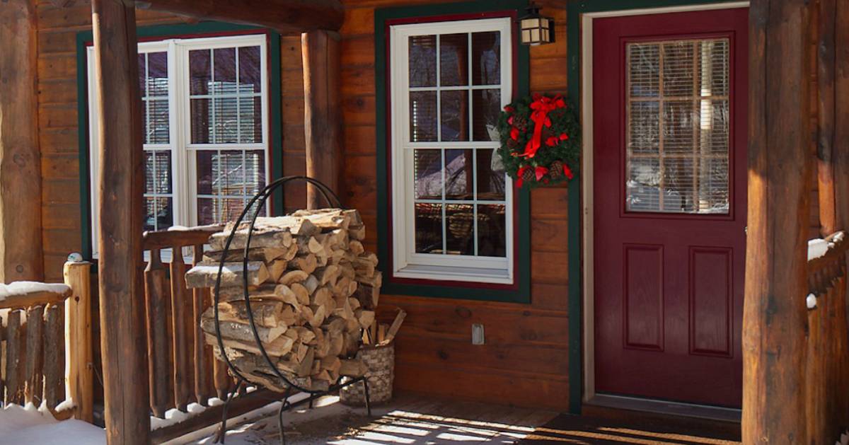 entrance to cabin with stacked logs