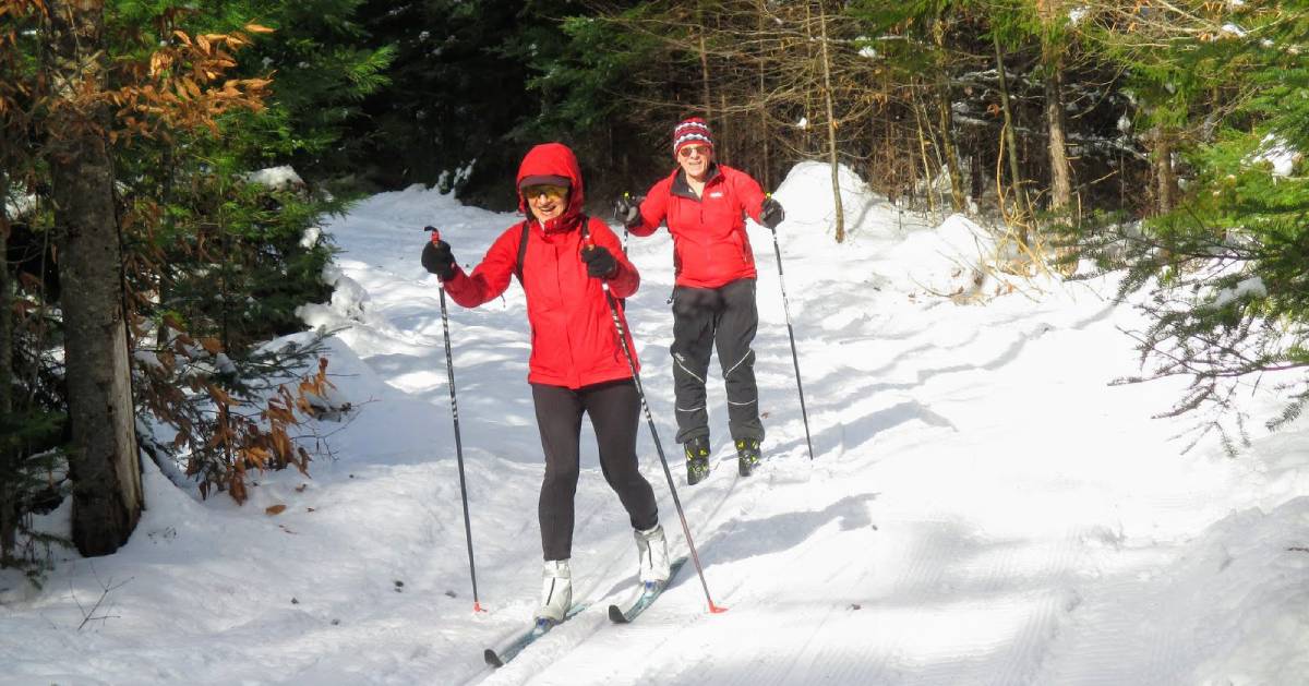 two skiers on trail