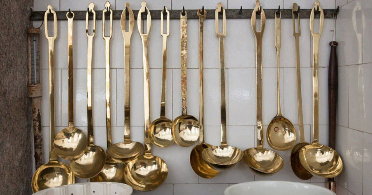 ladles hanging from a wall