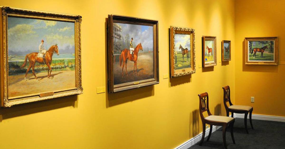 yellow walls with paintings of horses on them