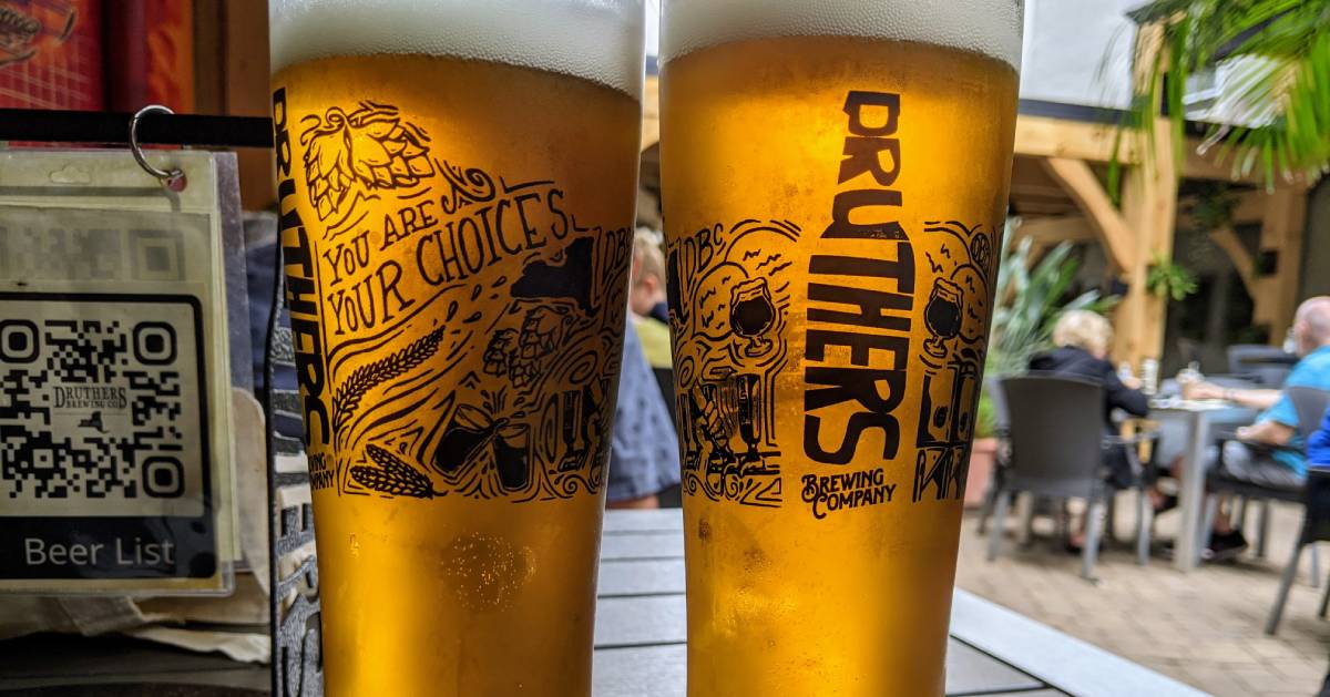 two full Druthers beer glasses