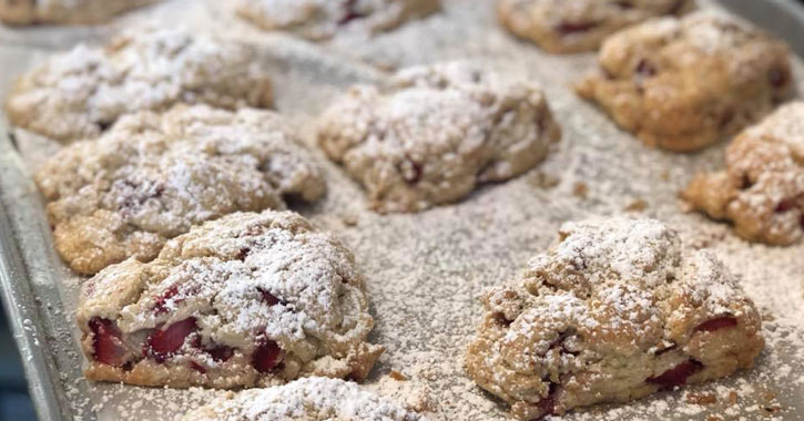 a tray of what looks like strawberry scones