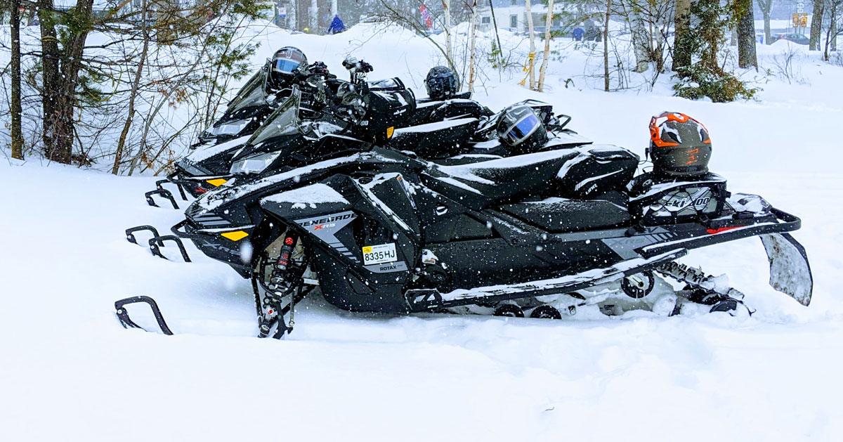 a group of snowmobiles parked on snow