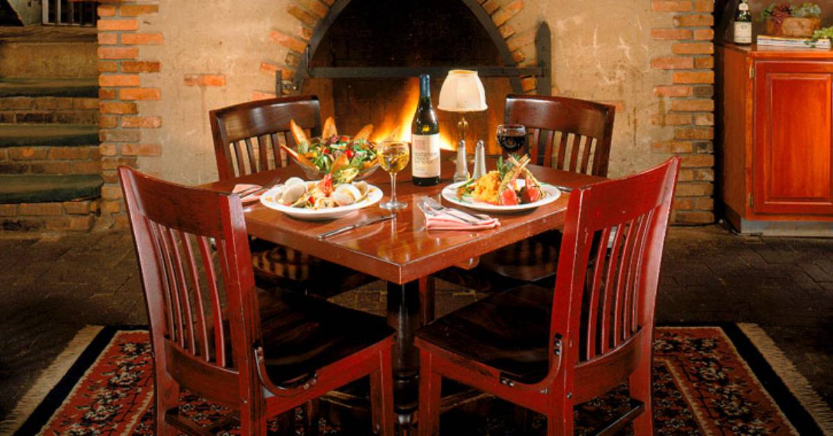 dining room table in a restaurant by a fireplace