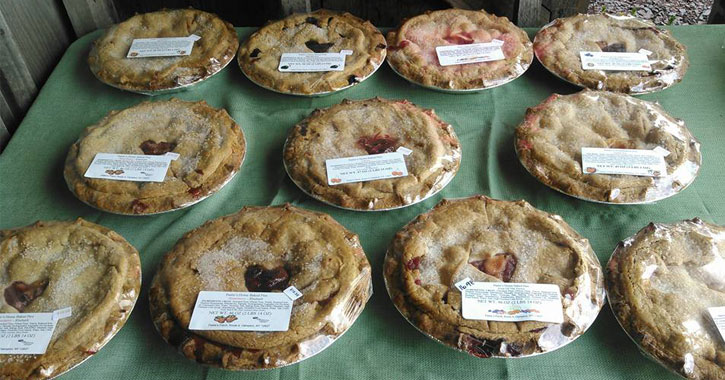 a display of multiple fruit pies