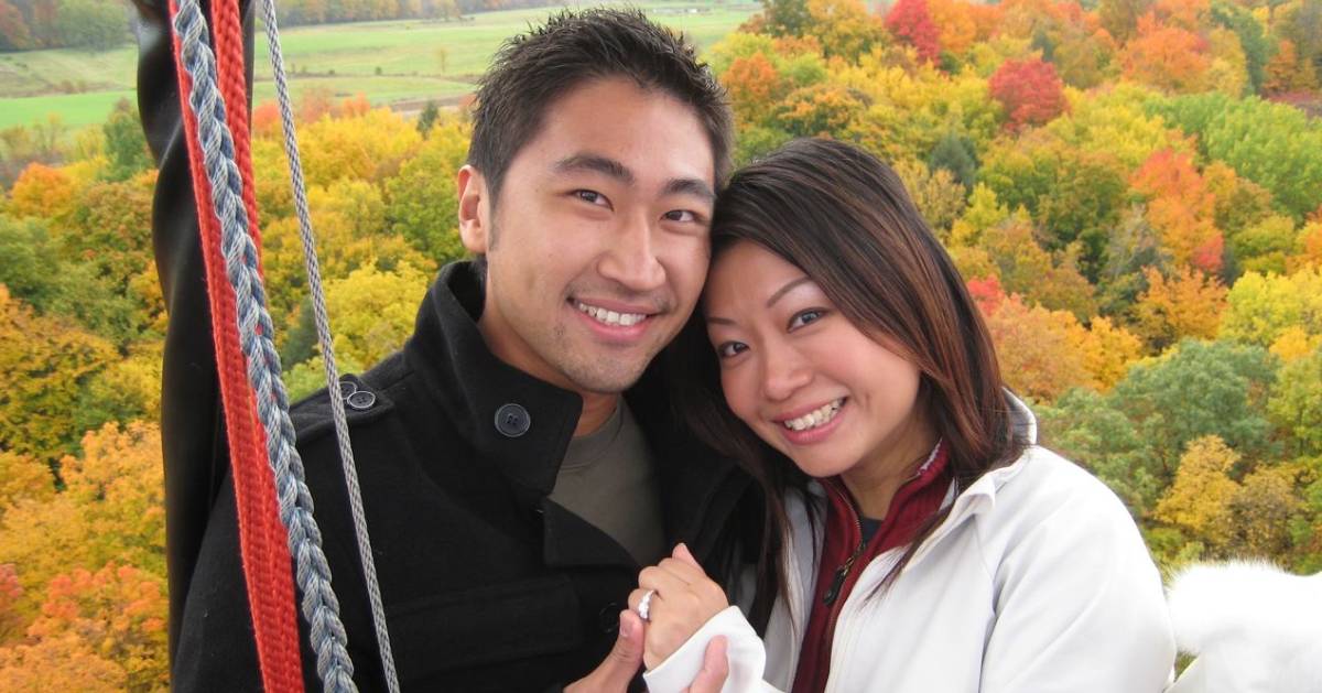 an engaged couple on hot air balloon showing off the ring