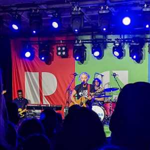 hanson performing at an indoor venue