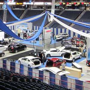 an overhead view of people at an indoor auto show