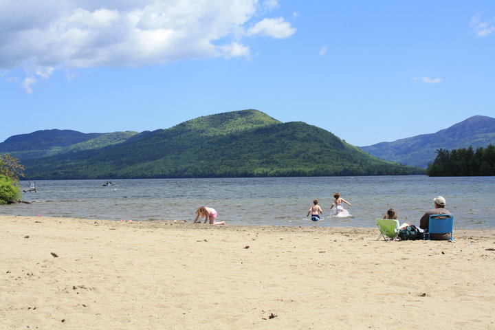 people on a beach on lake george