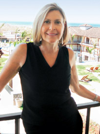 woman leaning against a balcony railing