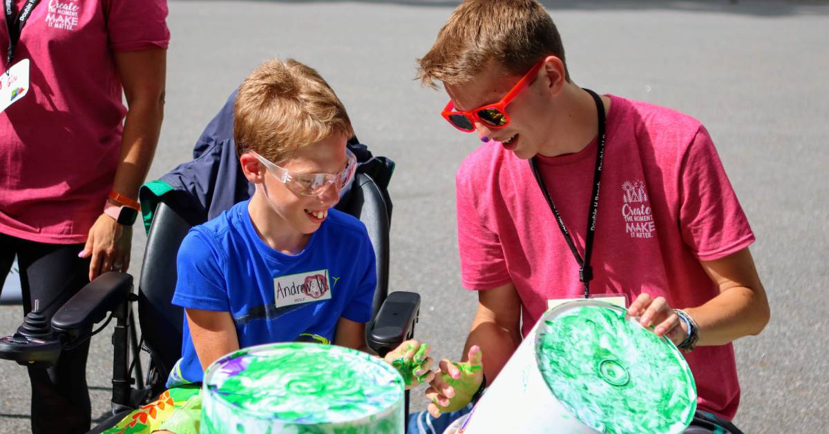 Counselor and Camper painting buckets