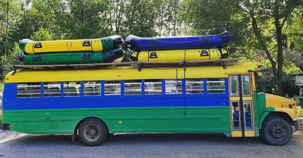 colorful bus with rafts on top