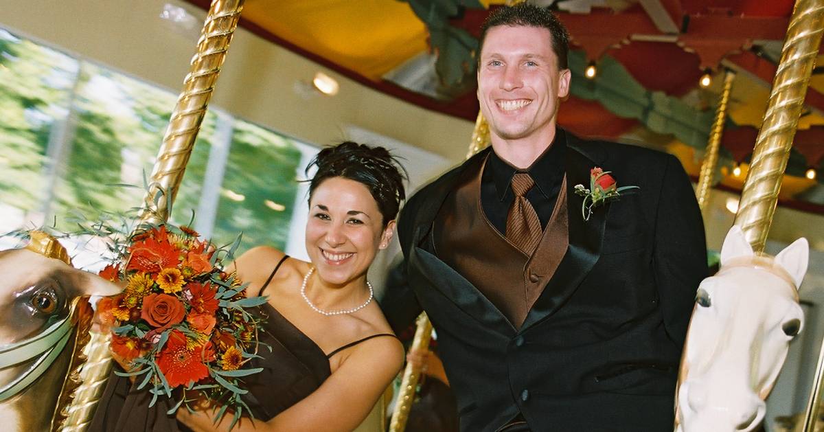 bridesmaid and groomsman on carousel
