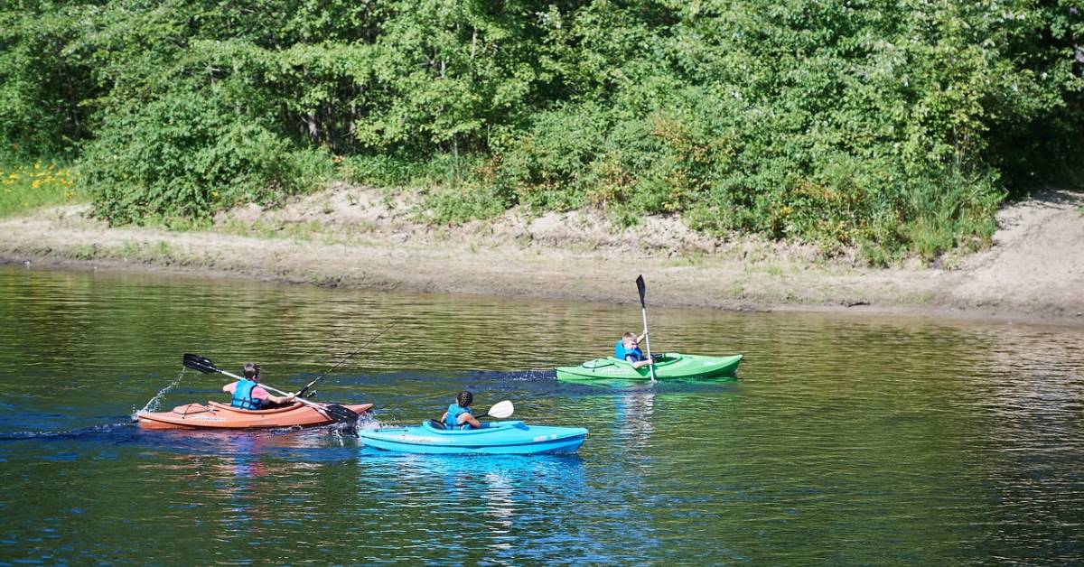 three people kayaking on a river