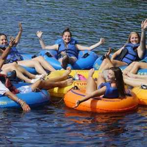 a bunch of young women on floating tubes