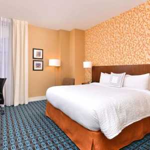 hotel room with large bed and work desk