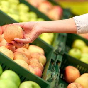 grocery store apple in hand