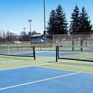 people play pickleball on an outdoor court