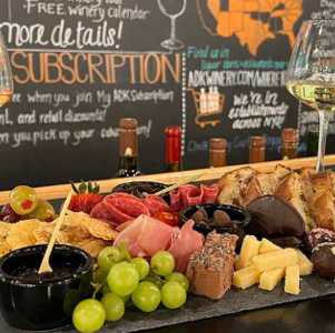 wine glasses and cheese and fruit board