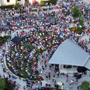 people outdoors at a concert by a city street