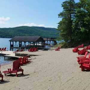 red lounge chairs on a sandy lake beach