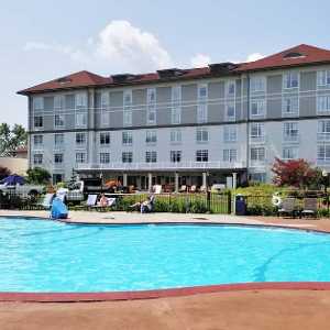 two hotel room beds on left, patio on the right