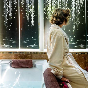 woman seated at spa tub