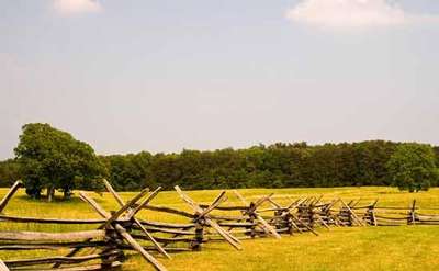 old style wooden fence dividing two sections of a battlefield
