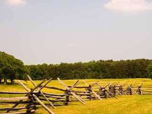 old style wooden fence dividing two sections of a battlefield