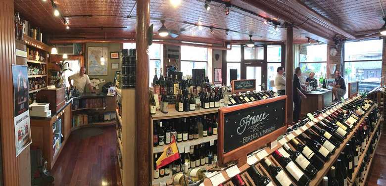 inside of wine store, staff at the counter ready to serve you