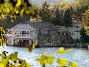 view of bed and breakfast across the water through trees