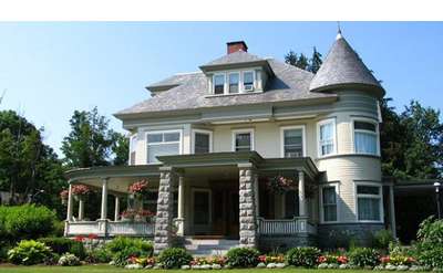 a Victorian-style bed and breakfast with wrap around porch