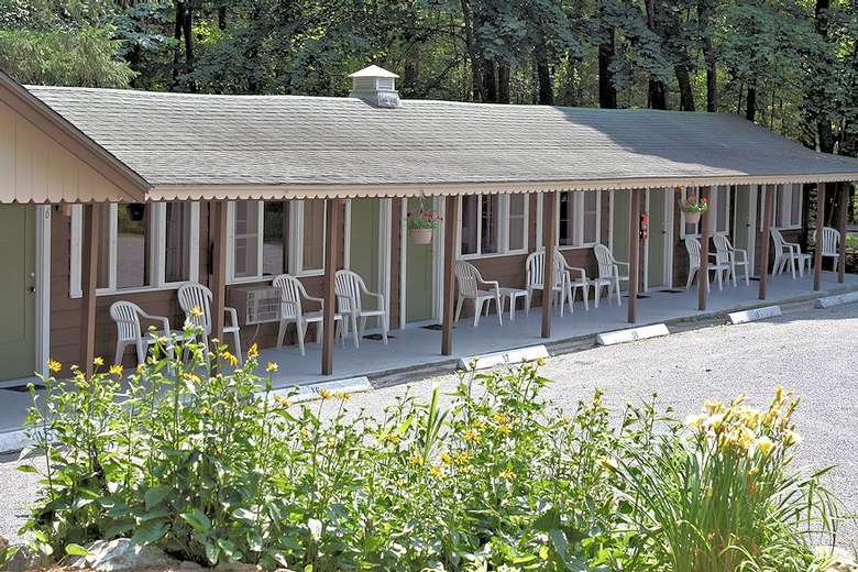 motel unit with white chairs out front