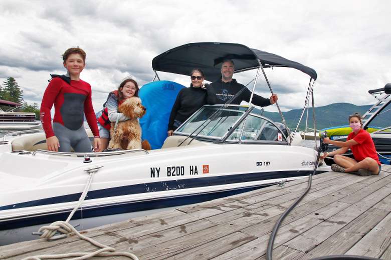 family with dog on boat
