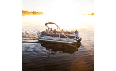 people in a boat at sunset