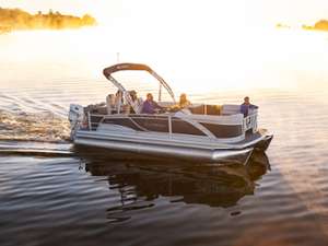 people in a boat at sunset