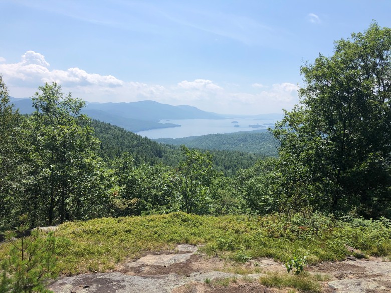 view of lake george from a hill in the summer
