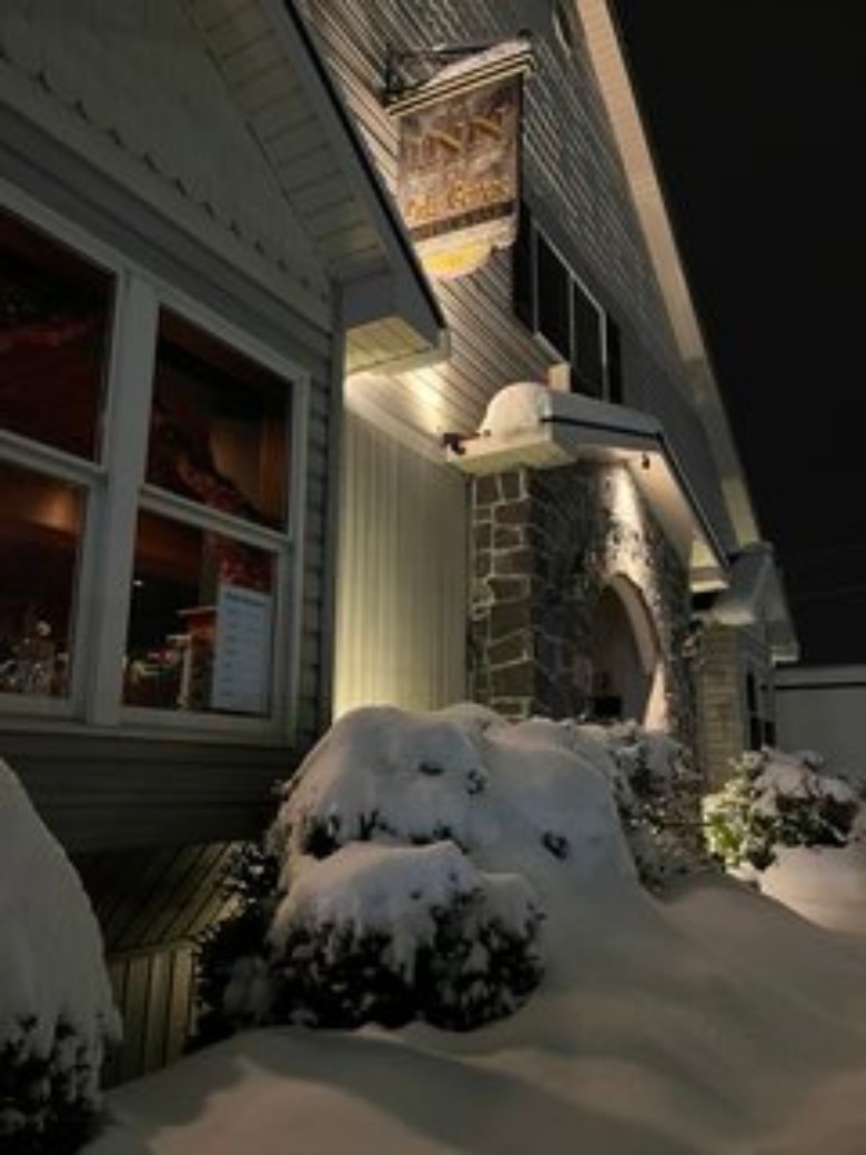 exterior of an inn with snow on the ground