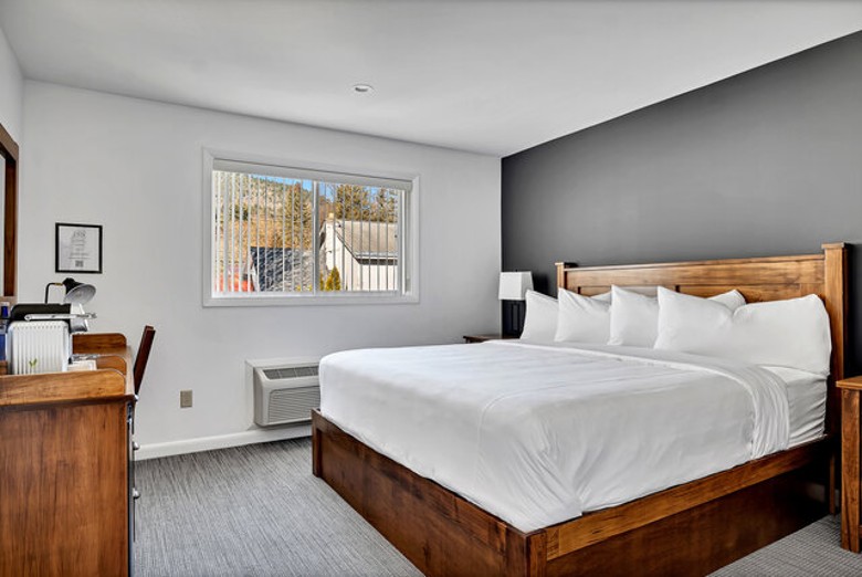 a modern hotel room with a large bed and desk